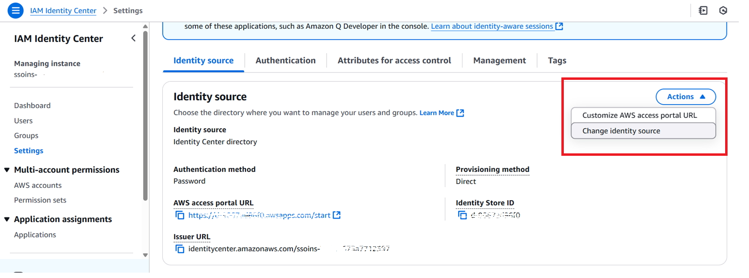 Screenshot of the IAM Identity Center settings page, focused on the "Identity source" tab. The page displays details such as identity source, authentication method, AWS access portal URL, issuer URL, and identity store ID. A dropdown menu labeled "Actions" is expanded in the top-right corner, showing options to "Customize AWS access portal URL" and "Change identity source," highlighted with a red box.