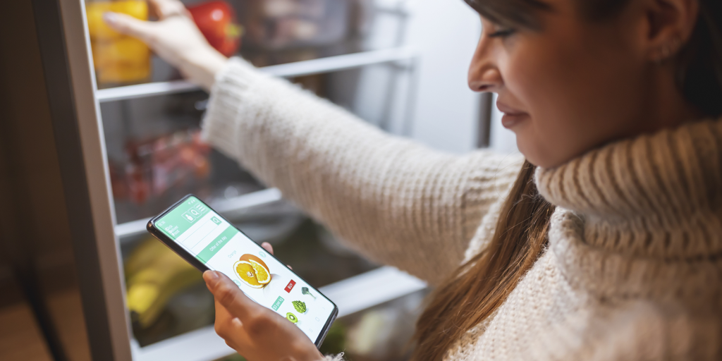 Woman ordering groceries online for home delivery
