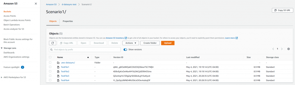 The S3 console confirms that the four objects have been transferred to the S3 bucket. Note that there is only one version of each