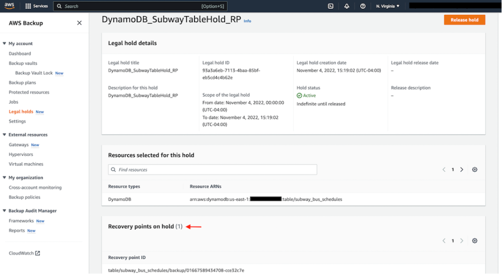 AWS console screen showing the newly created Legal hold for Amazon DynamoDB resource with a red arrow highlighting the recovery point